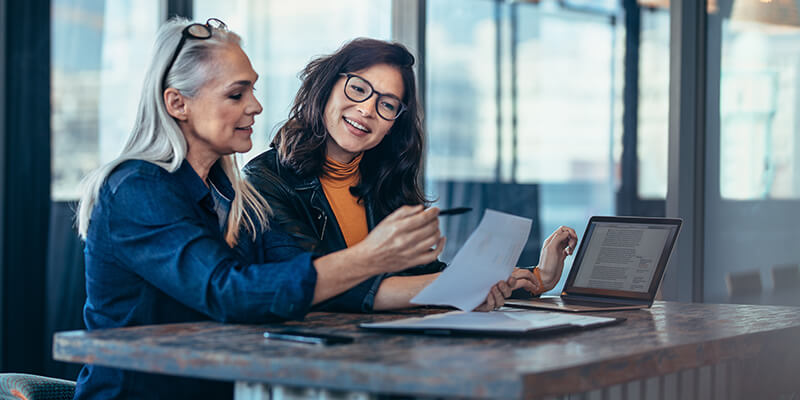 Two Women Going Through Paperwork