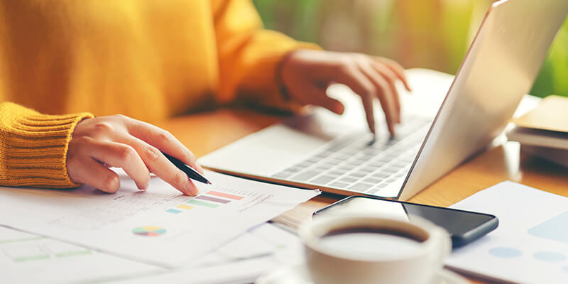 Woman On Laptop With Coffee