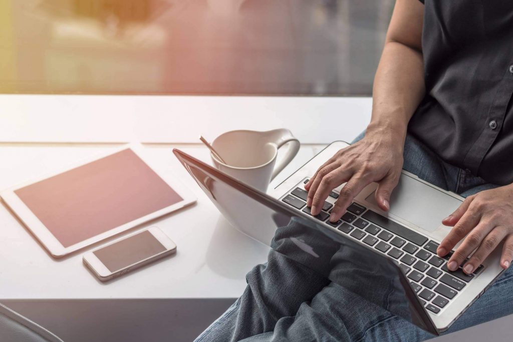 Man on laptop with coffee