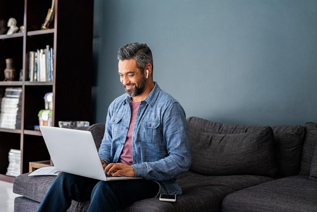 Man Working On Laptop From Home