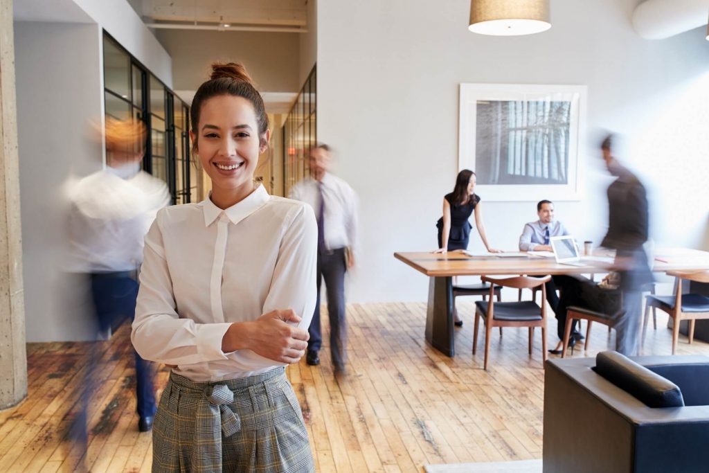 Young Woman In Busy Office