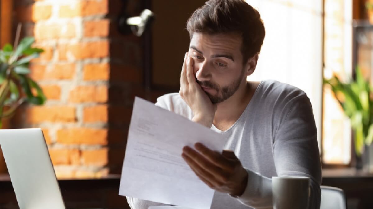 Man Looking At Paperwork