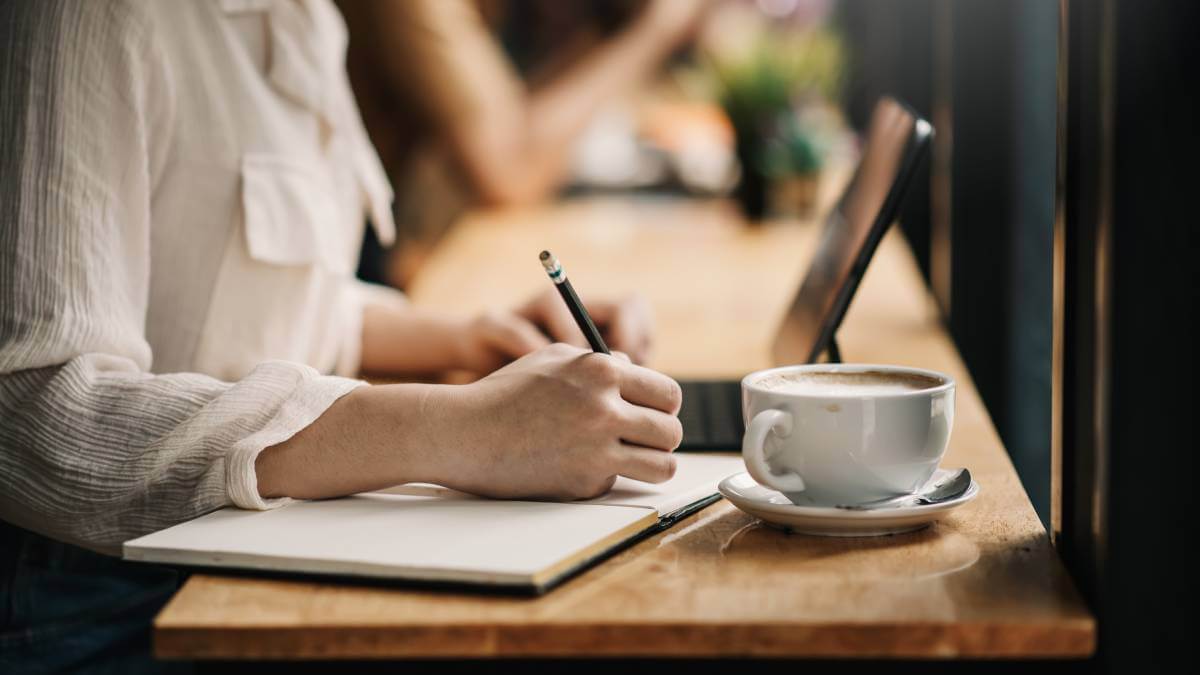 Woman Writing In Notebook