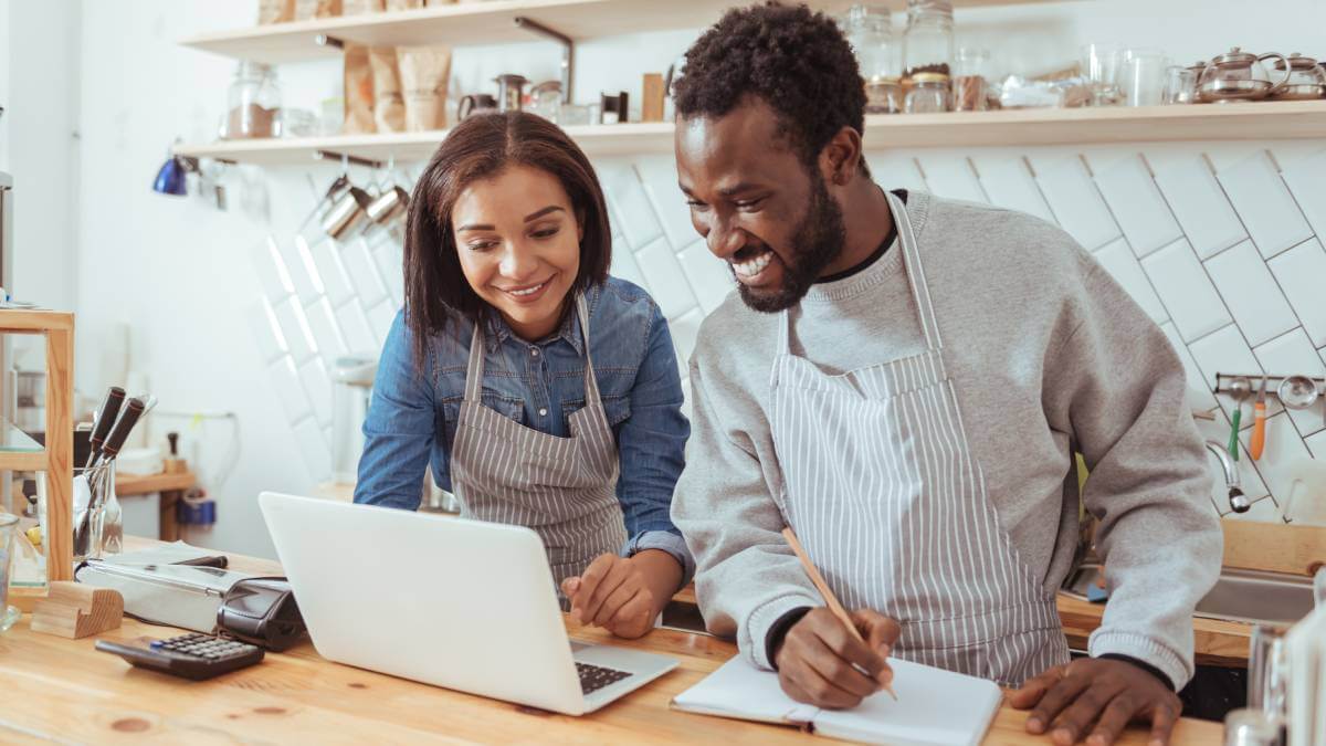 Happy Business Owners On Laptop