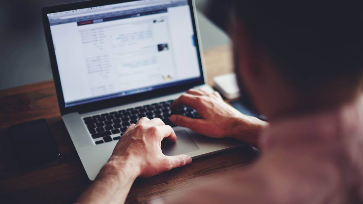 Man Typing On Laptop