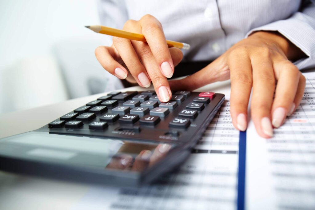 Woman's Hands Using Calculator