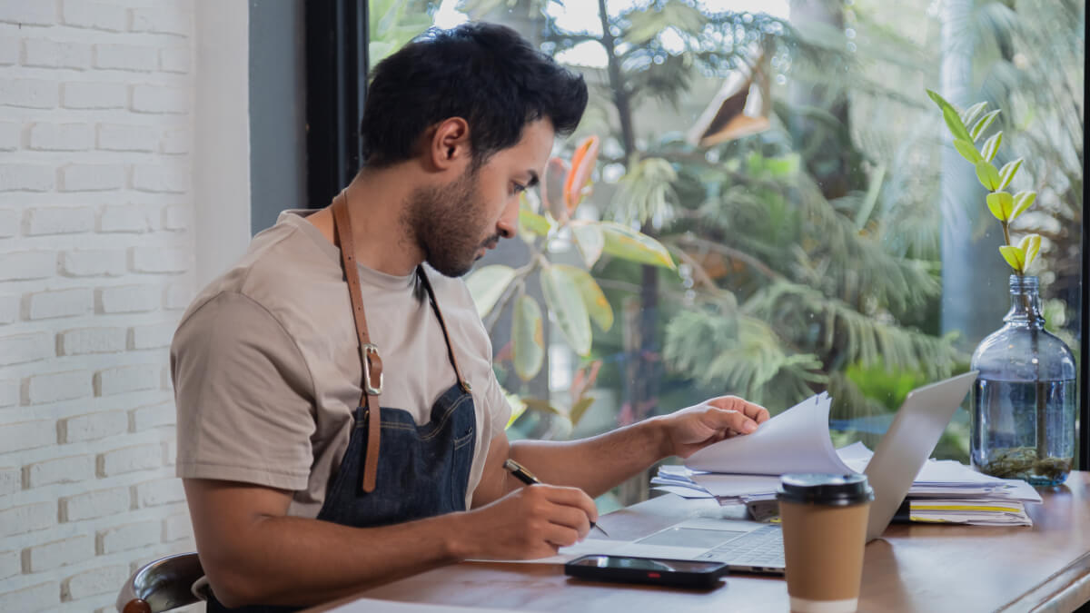 Cafe manager doing expenses