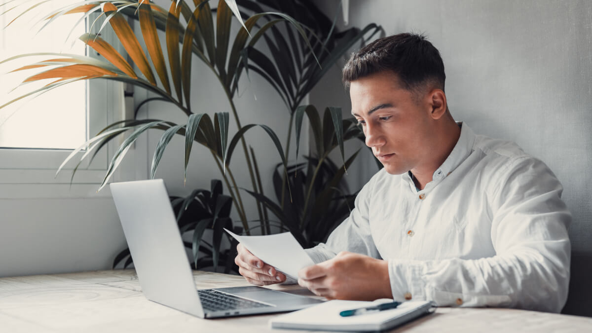 Young man looking at paper