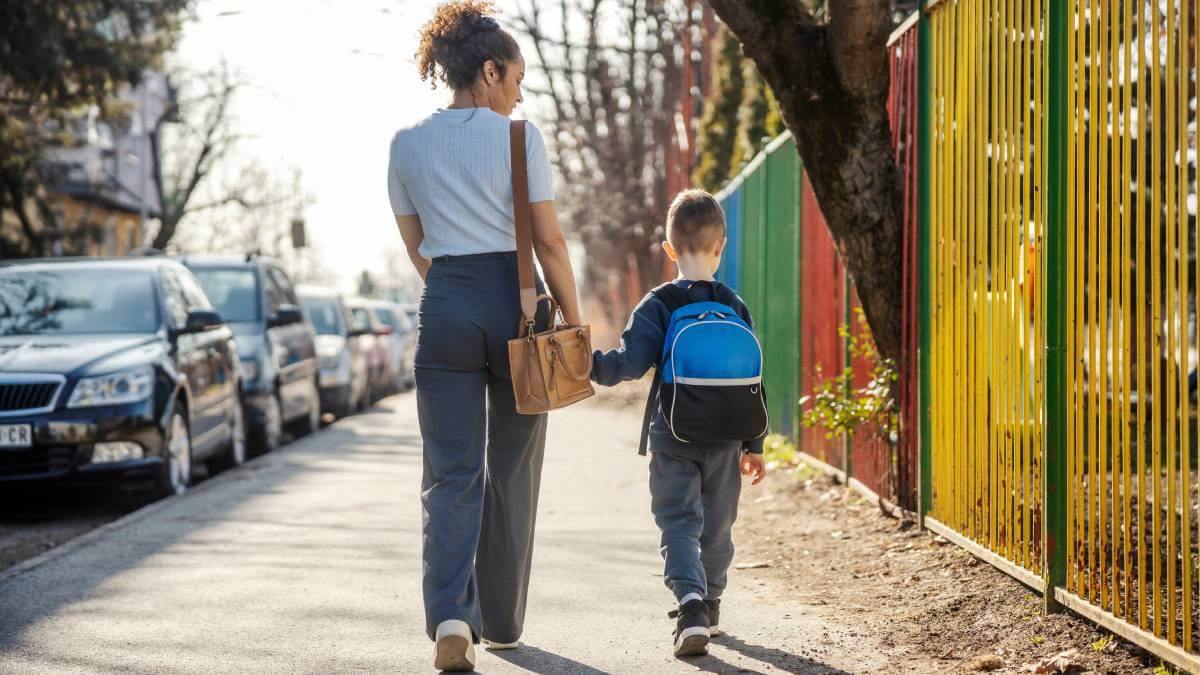 Mother walking young son to school