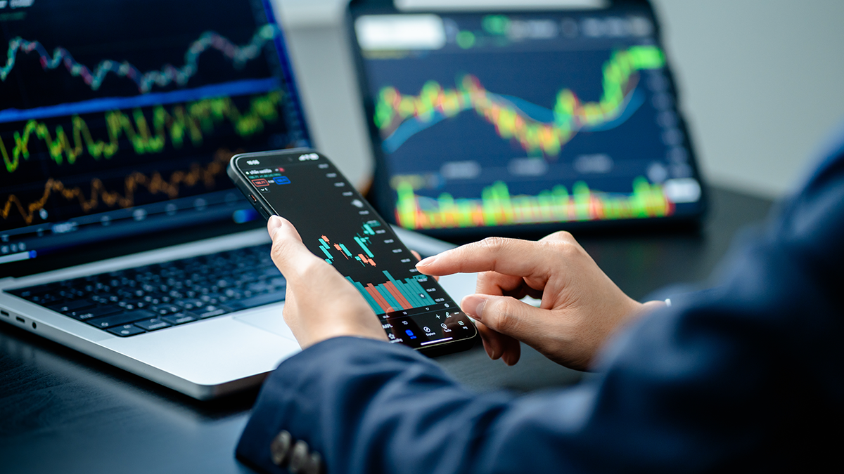 A man trading on his phone