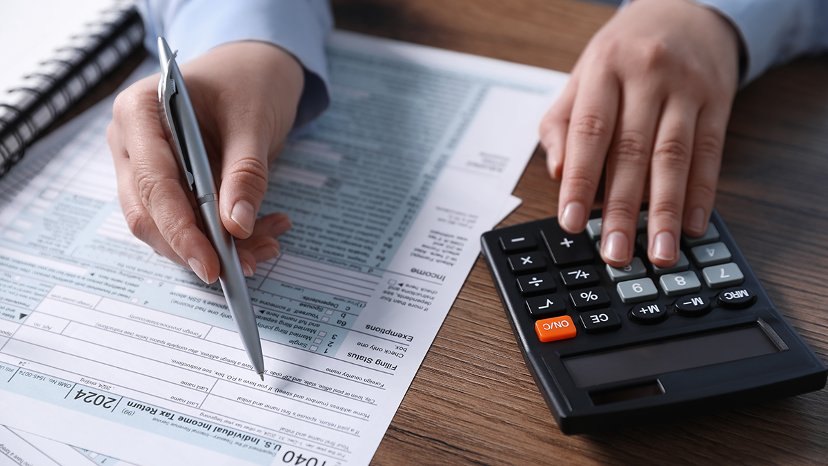 a-man-writing-in-a-tax-form