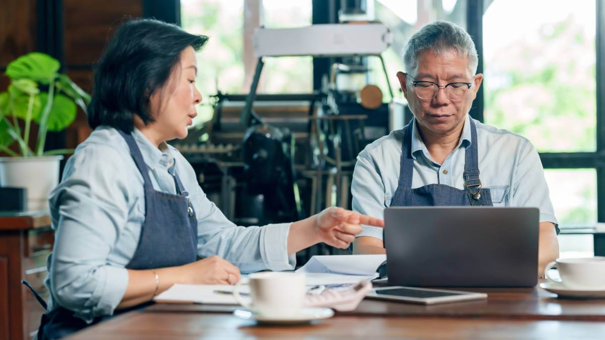 Business owners on laptop talking
